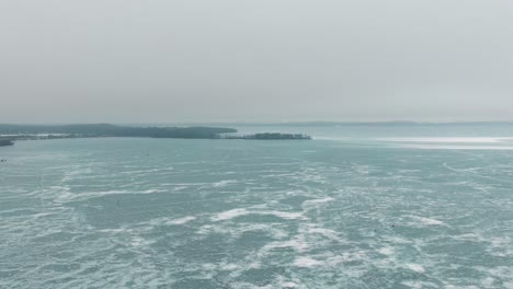 aerial-of-frozen-Lake-Mendota,-Madison,-Wisconsin-winter-perch-ice-fishing-haven