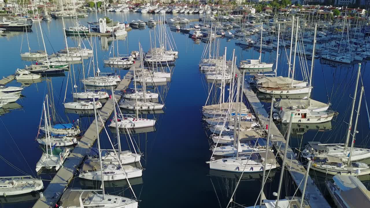Turkey, Marmaris,Drone footage move forward over sailboats at a marina on a sunny day.