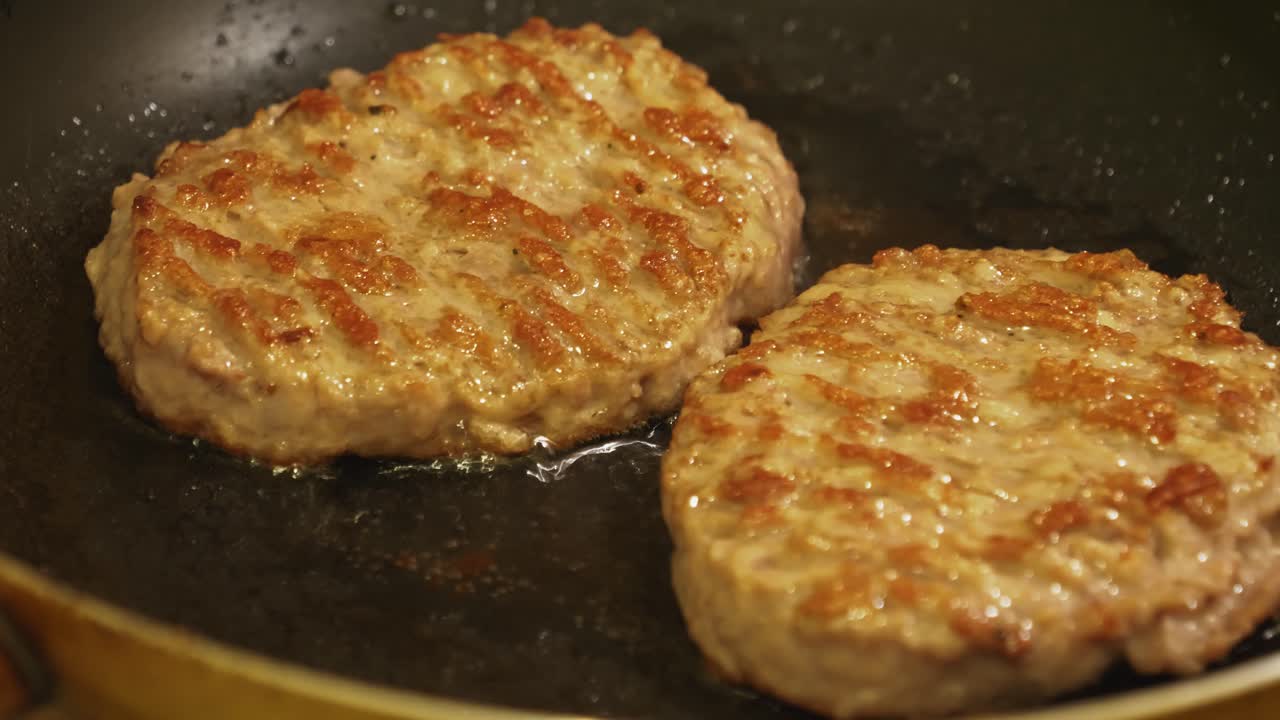 Close up view of meet being fried for burgers