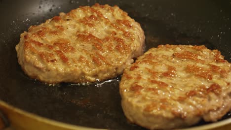 close up view of meet being fried for burgers
