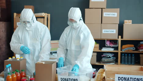 volunteers in protective gear sort donations