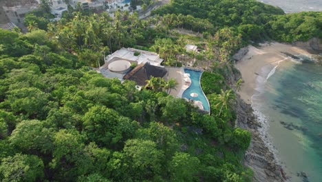 aerial view of tropical resort hotel beside beach in huatulco