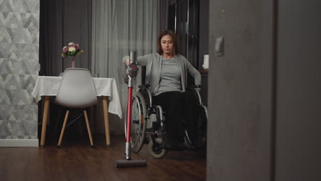 woman with paralysis removes dust in house using device