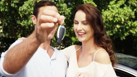 couple interacting with each other near car