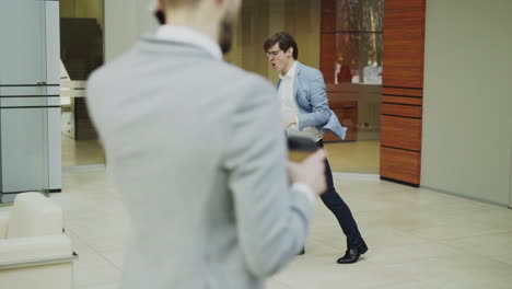 businesspeople dancing in office corridor