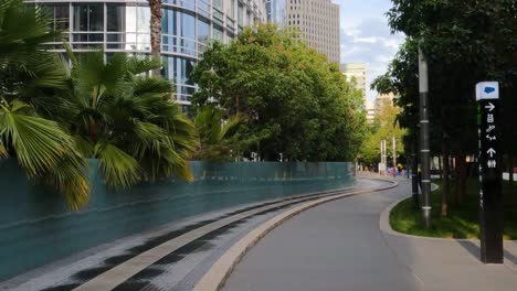 urban pathway with greenery and modern buildings