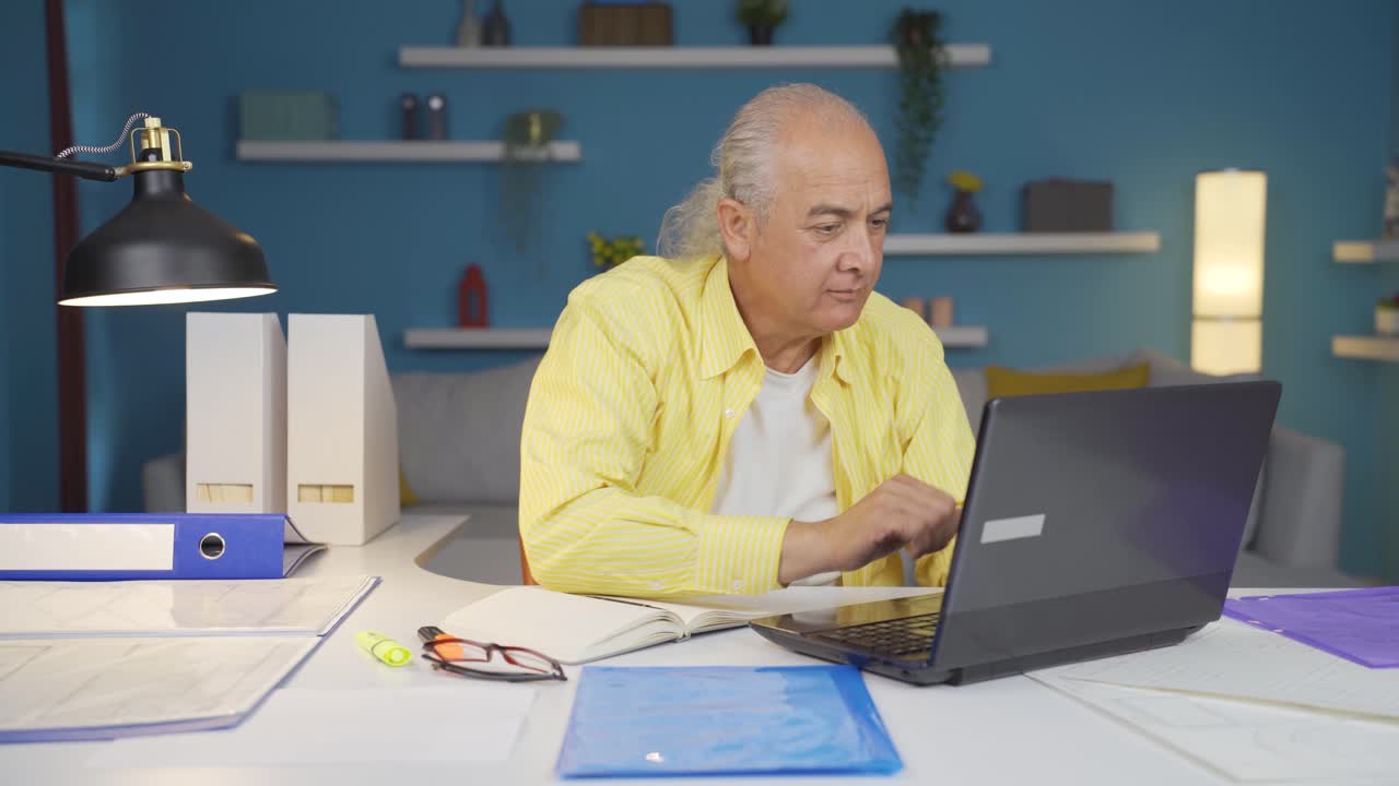 Home office worker old man completes his work and relax.