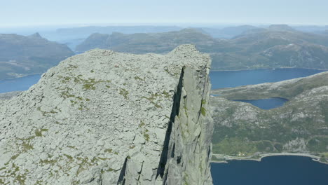 aerial footage of hornhelen in norway. this is an 860-meter tall cliff straight up from the fjords bellow