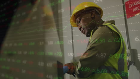 animation of statistics and data processing over african american man working in warehouse