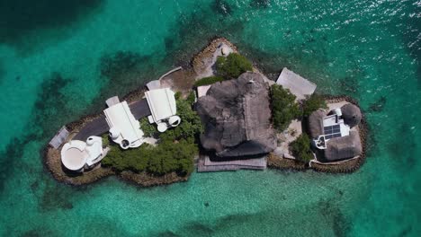 Top-Down-Aerial-View,-Small-Island-Surrounded-With-Turquoise-Caribbean-Sea-Water