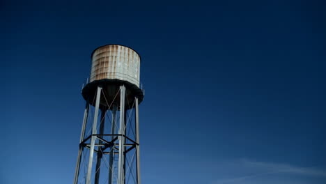 old water tower against a deep blue sky