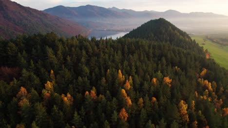 Autumn-landscape,-peaceful-valley,-hill-and-river,-evening-drone-aerial