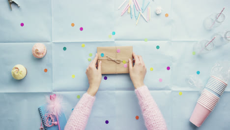 Top-view-woman-holding-birthday-present-planning-party-hands-from-above---Red-Epic-Dragon