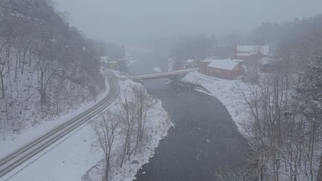 Rosendale,-New-York,-on-a-snowy,-beautiful-winter-day,-during-a-nor'easter,-as-seen-from-the-high-trestle-bridge,-over-the-Rondout-Creek,-on-the-Wallkill-Valley-rail-trail-far-above-the-village