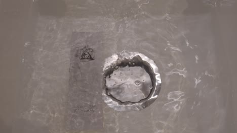 putting sharping stone for soaking into the sink with water