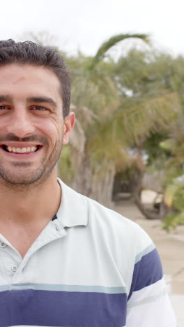 vertical video of portrait of happy caucasian man at beach house
