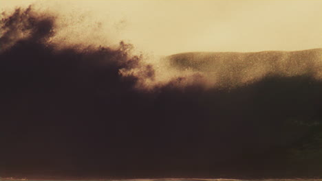 glistening waves crashing in slow motion at sunrise, golden light and offshore mist rising from the pacific ocean