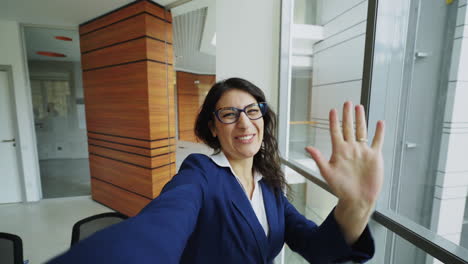 business woman taking selfie in modern office