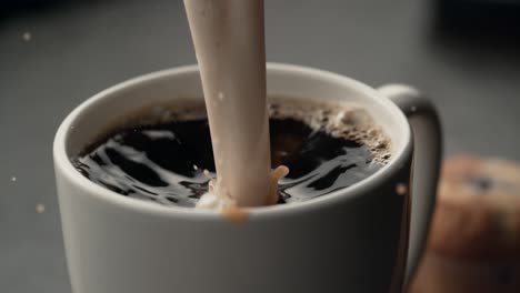 Cream-splashing-into-coffee-in-Slow-Motion