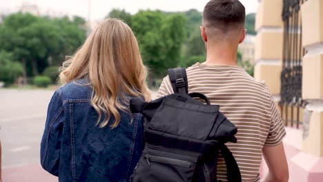 two young students walking down the street