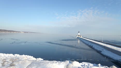 light house on a winter sunny afternoon water completly frozen