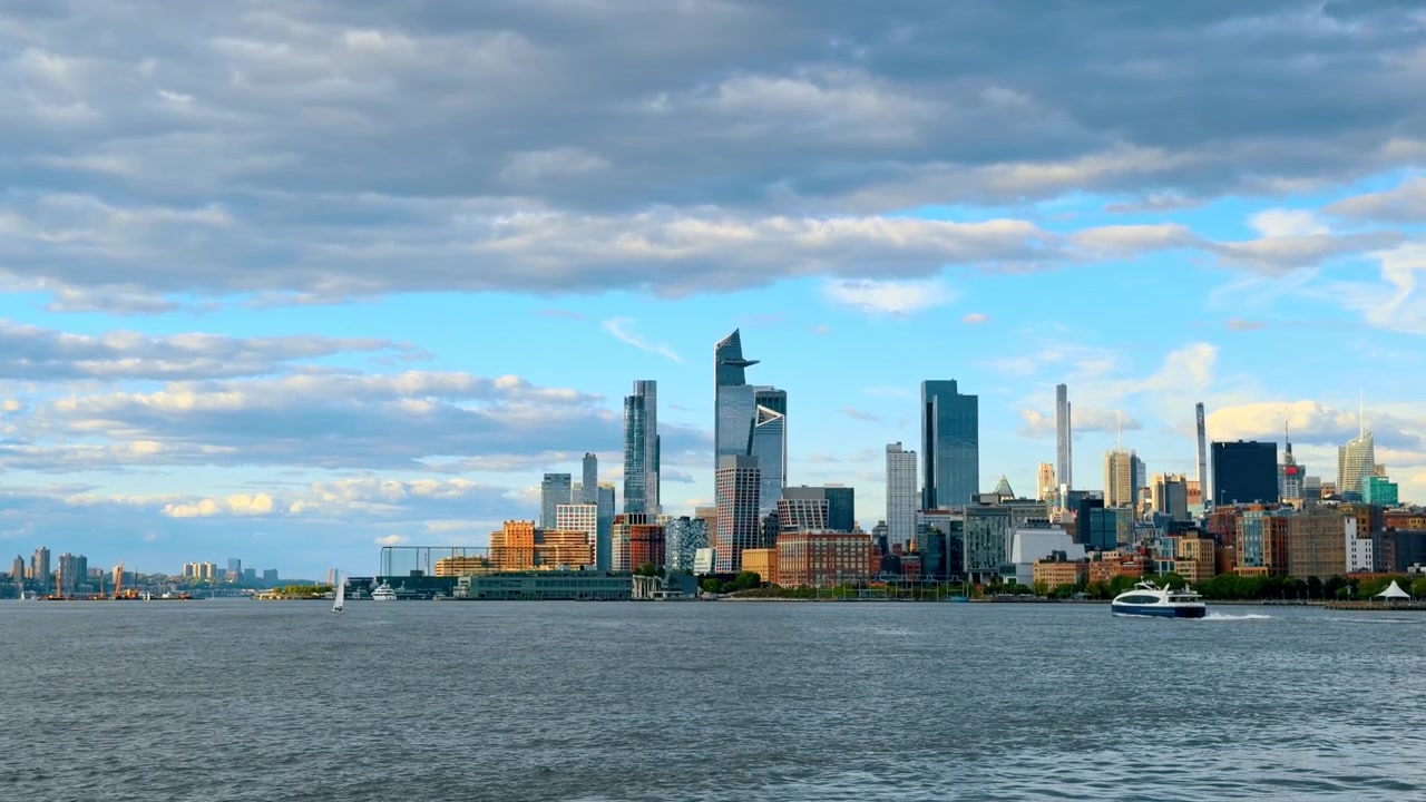 Skyline di Hudson Yards e piattaforma di osservazione The Edge, New York. Vista dello skyline del moderno quartiere di Hudson Yards dal fiume sotto un cielo azzurro nuvoloso a Manhattan.