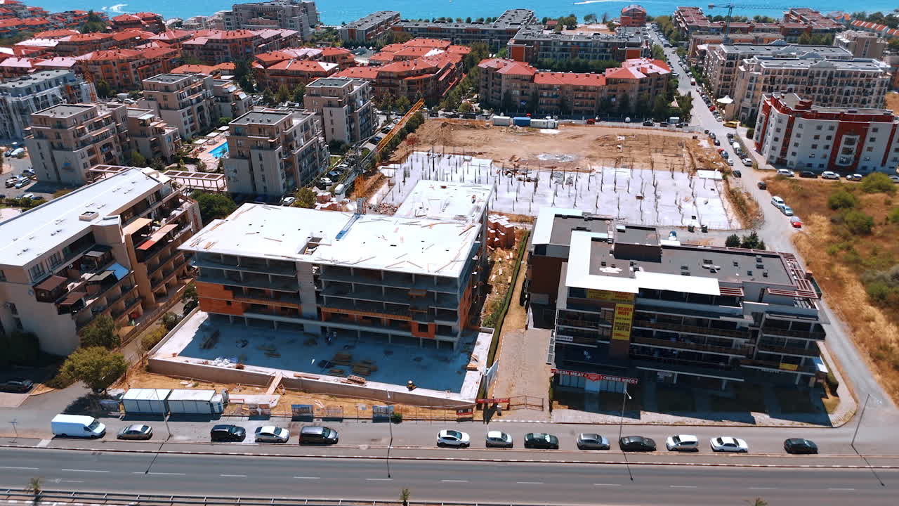 Varna, Bulgaria, 29 June 2025: Wide coastal scene with new resort construction. The shot captures a large foundation and building frames against the backdrop of the Black Sea