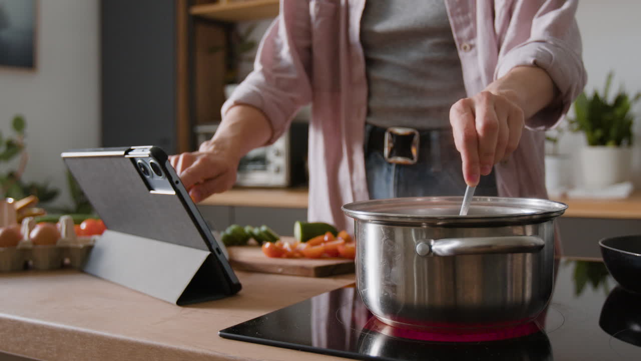 Woman Cooking in the Kitchen with Tablet
