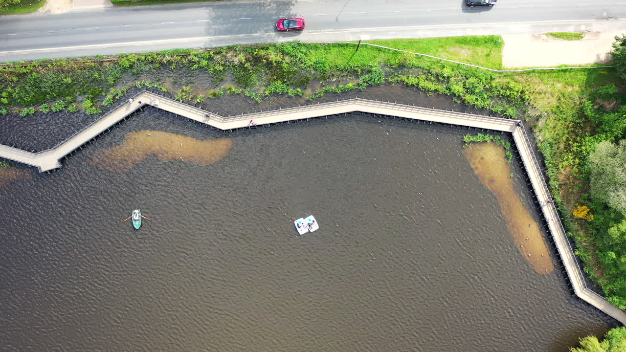 Aerial birds eye view Petersfield Heath Pond row boats Sunny day UK 4K