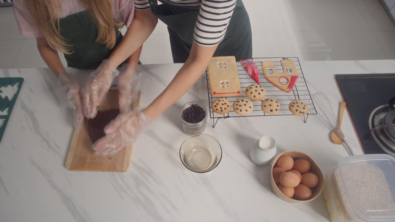 Daughter and Mother Making and Decorating Christmas Cookies