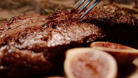 cutting delicious steak with knife and fork, checking red color of meat