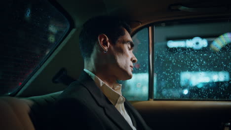 sleeping entrepreneur napping rainy window car close up. pierced man having rest