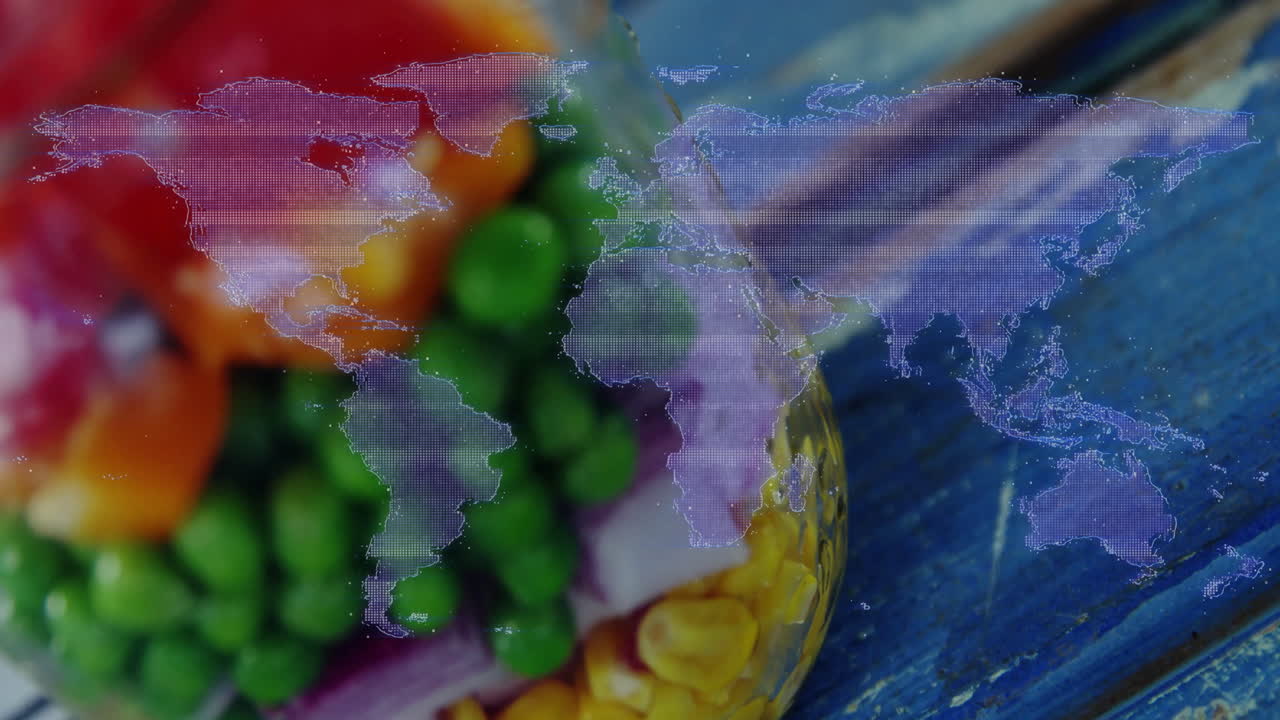 Colorful vegetables with world map animation overlay on blue wooden surface