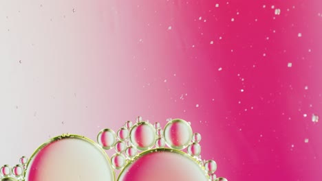 Animation-of-bubbles-moving-on-white-and-pink-background-with-copy-space