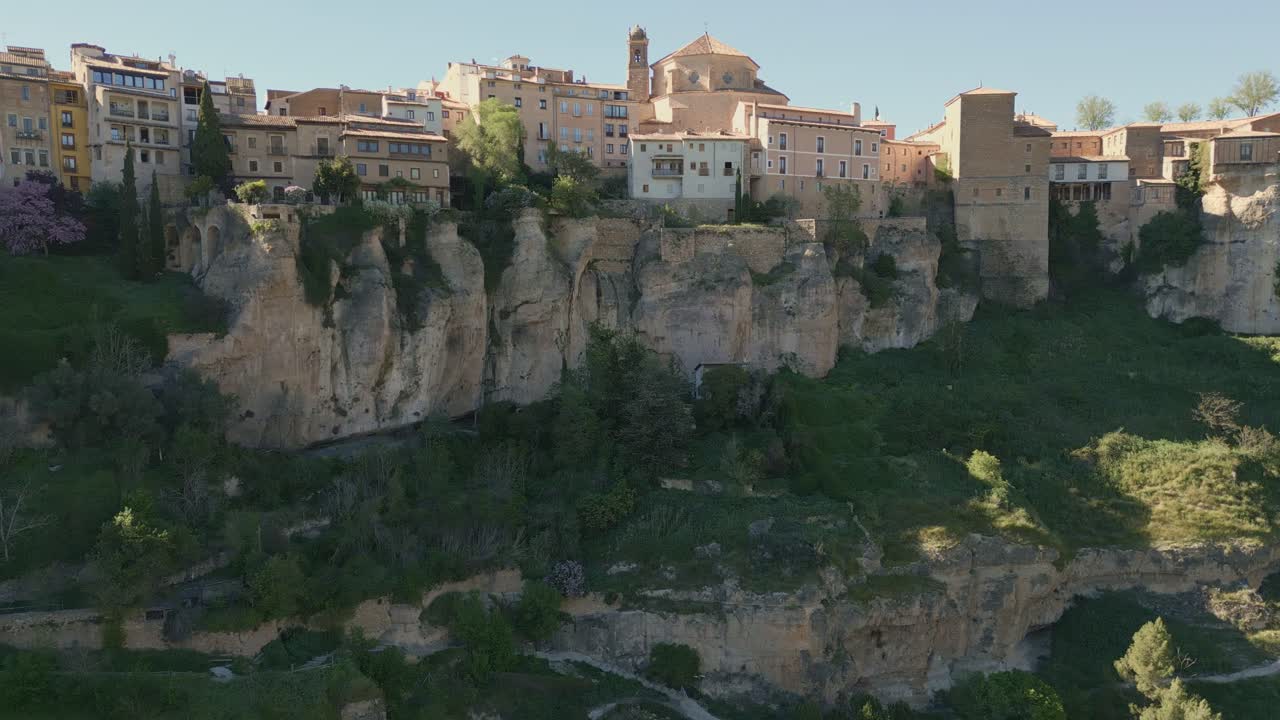 Houses hanging next to rocky precipice. Panoramic aerial view of medieval houses next to a cliff. Cuenca. Spain.