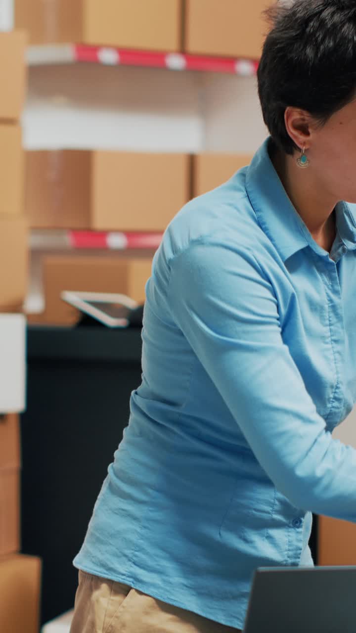 Vertical video: Young adult using merchandise from warehouse to prepare order