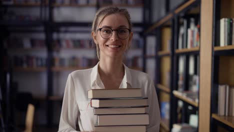 Girl-student-holding-a-lot-of-books-in-the-library,-paper-sheets-falling-around-her,-slow-motion