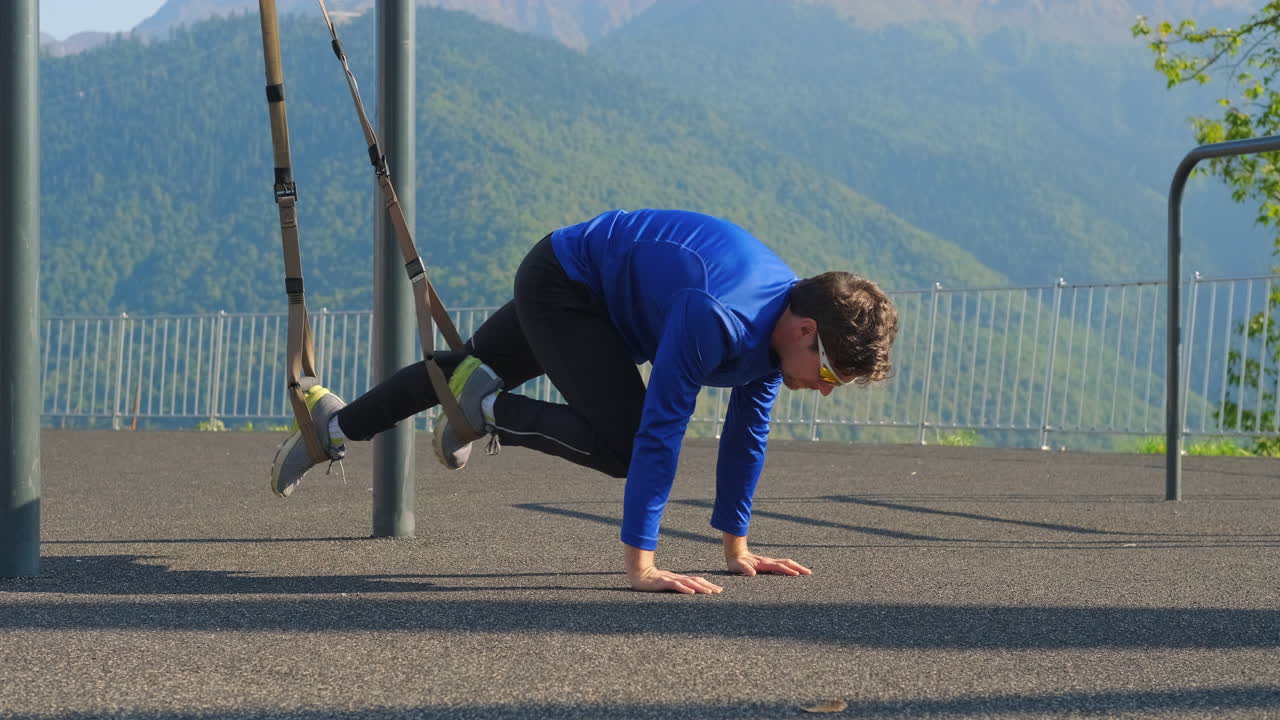 야외에서 서스펜션 훈련을 하는 남자
