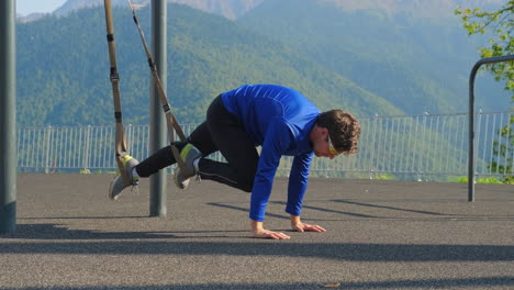 man doing suspension training outdoors