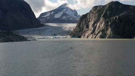 a drone shot of a sea plane on a glacier lake in the mountains of british columbia before take off