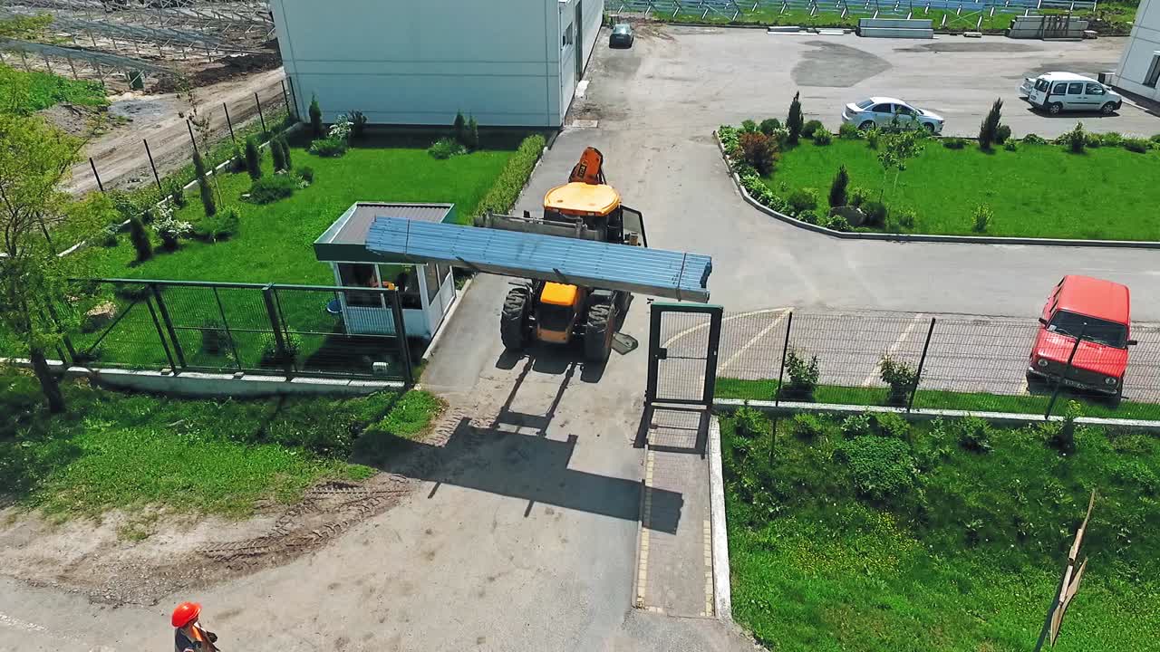 Machine on construction site. Aerial view of worker and heavy machine working at construction site