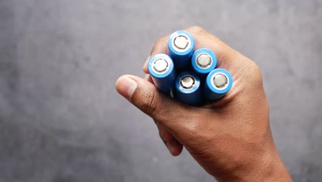 Close-up-of-holdings-batteries-on-black-background