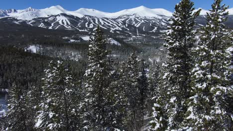 rising over the trees to reveal breckenridge ski resort