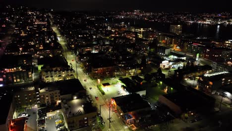 Aerial-view-of-traffic-on-the-streets-of-illuminated-suburbs-of-Seattle,-USA