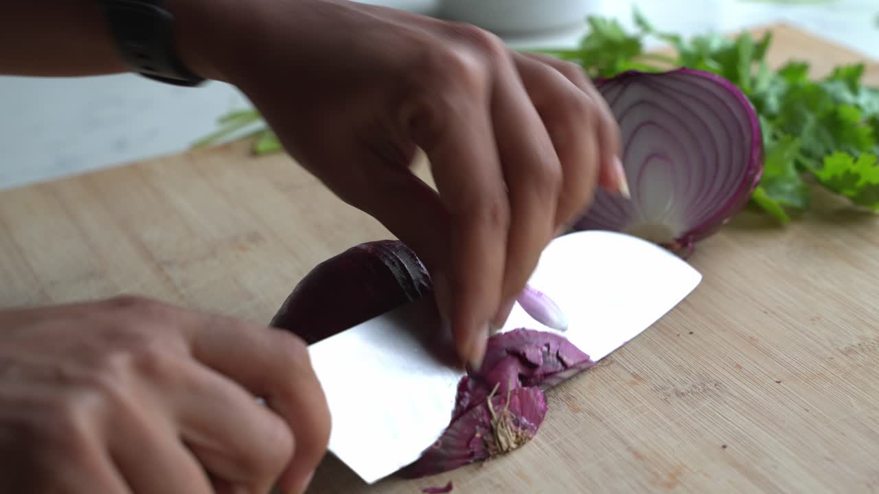 Slicing red onion ends shot of special ingredients to cook a meal two cans of beans rice plantain avocado red onion and cilantro