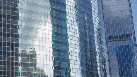 modern glass skyscrapers reflecting the sky