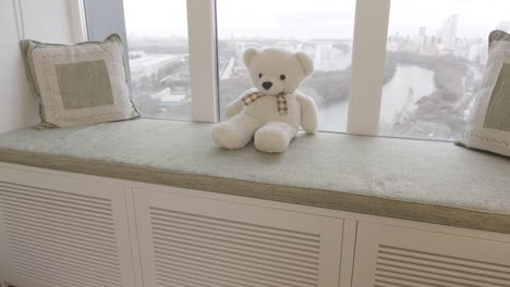 cozy window seat with teddy bear