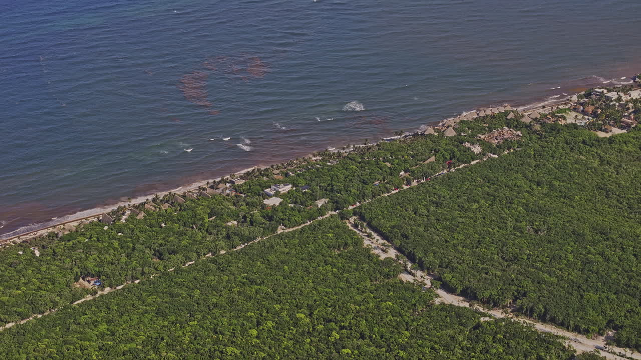 Tulum Mexico Aerial v17 high altitude zoomed shot, birds eye view drone flyover beachfront resort town surrounded by lush jungle forests in summer - Shot with Mavic 3 Pro Cine - July 2023