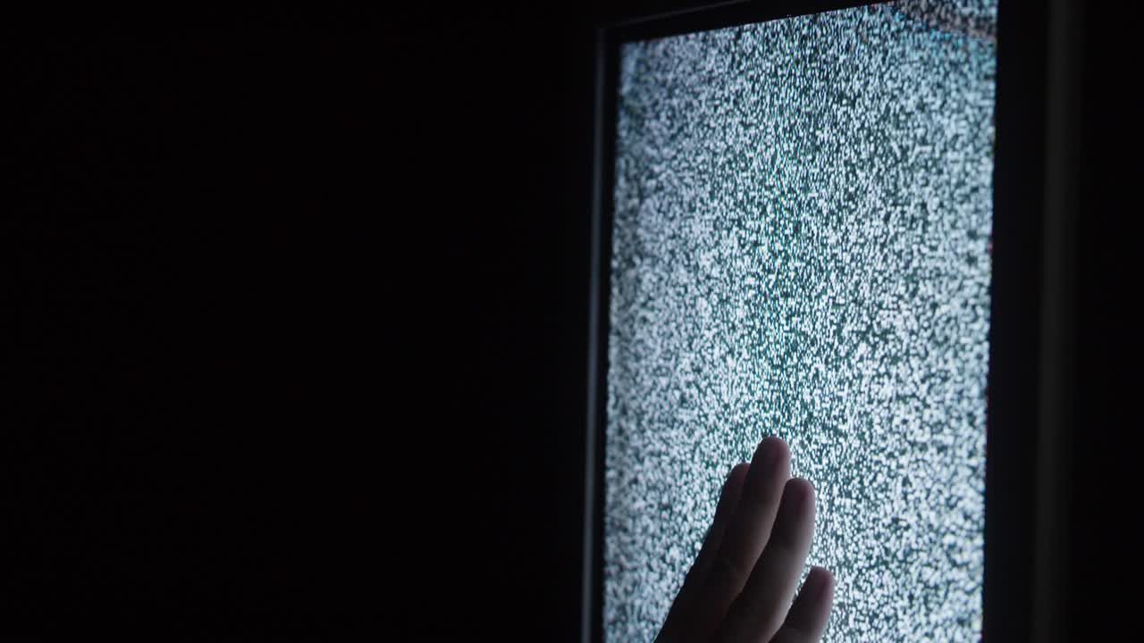 mano humana tocando vieja pantalla de televisión retro con ondas, señal ondulada dañada. primer plano de televisión anticuada rota con ruido, mala recepción de señal, concepto de cinematografía