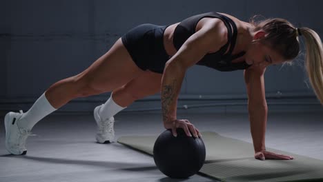 woman performing plank exercises with exercise ball